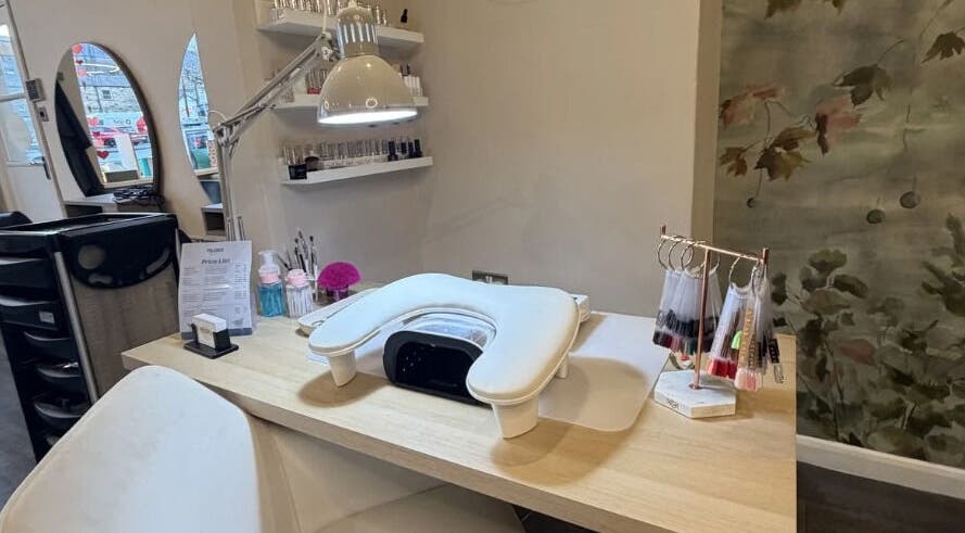 Pure's manicure desk with nail colour samples and a lamp